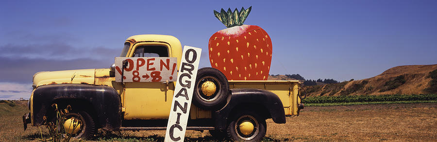 Old truck with giant strawberry Photograph by Timothy Hearsum