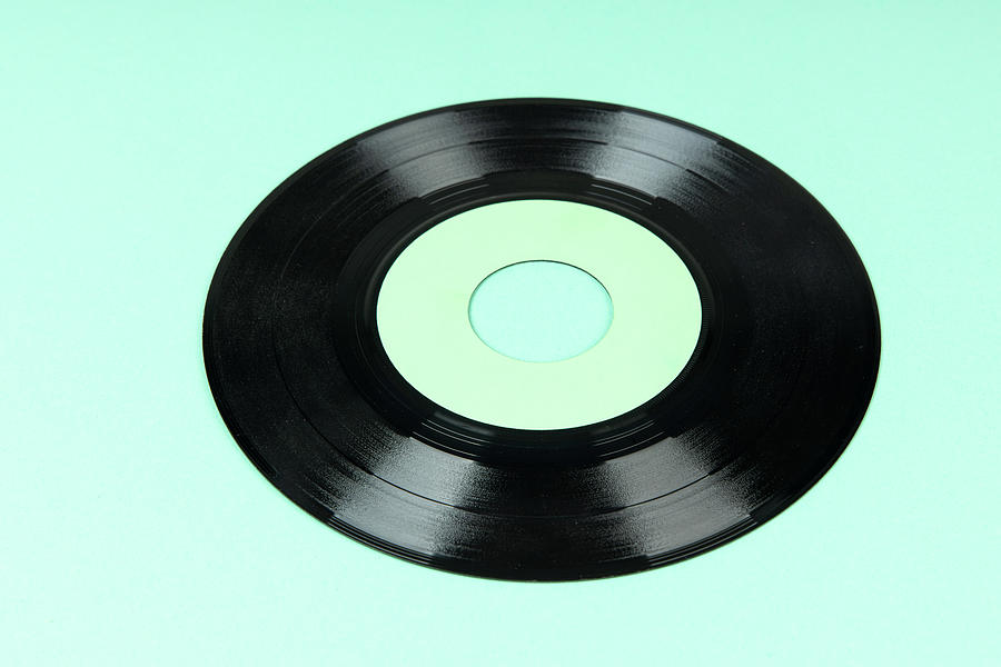 Old Vinyl Disc On Green Background. Old Vintage Vinyl Record. Photograph