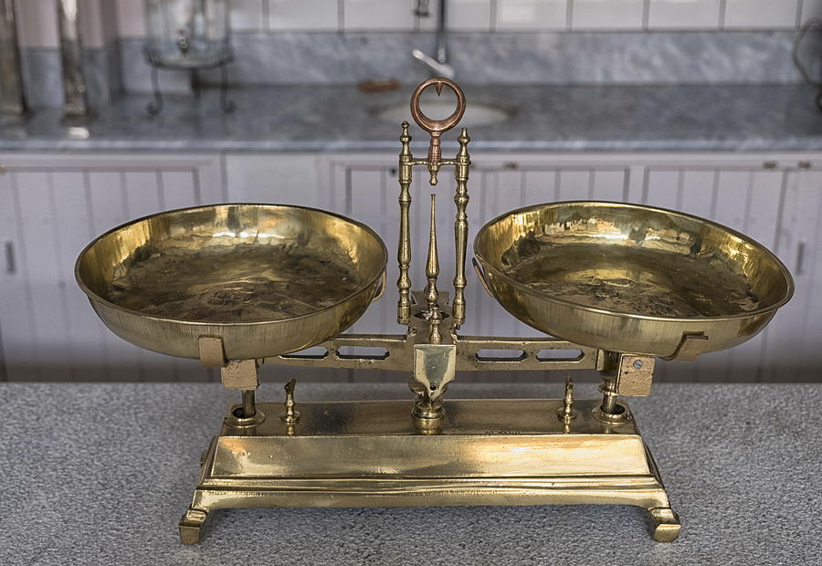Old weighing scale on a marble stand. Photograph by Emreturanphoto