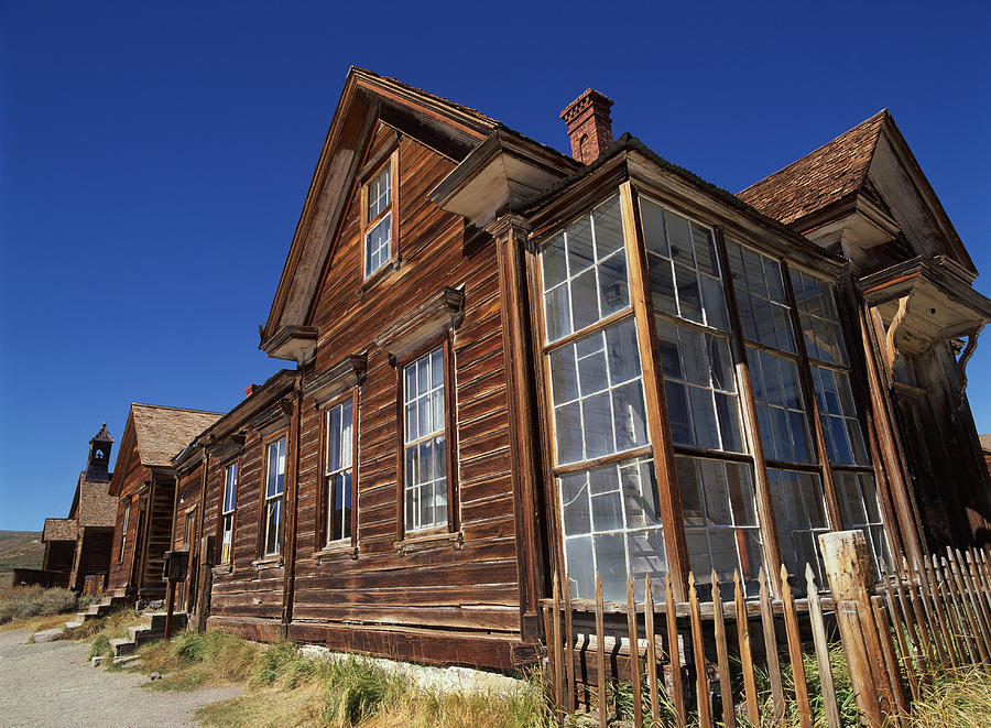 Old Wooden Buildings In The Ghost Town Of Bodie California Are Seen In The Noon Sun Photograph by Rubberball