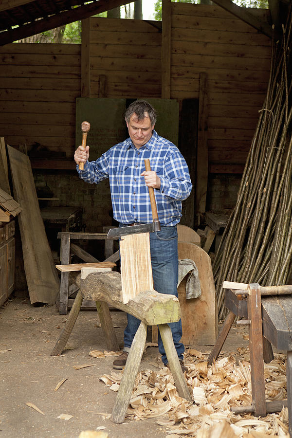 Older man carving wood in shop Photograph by Cultura RF/Bill Sykes