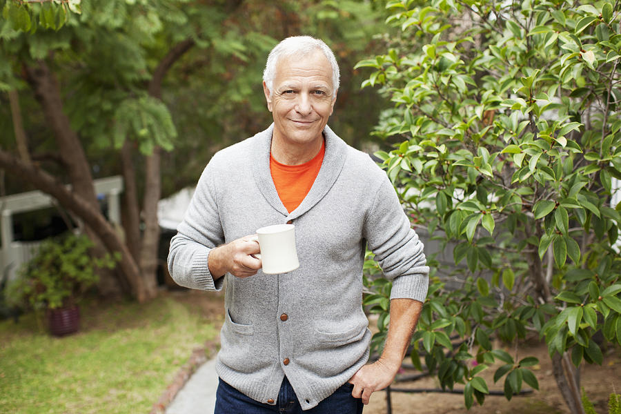 Older man drinking cup of coffee outdoors Photograph by Sam Edwards