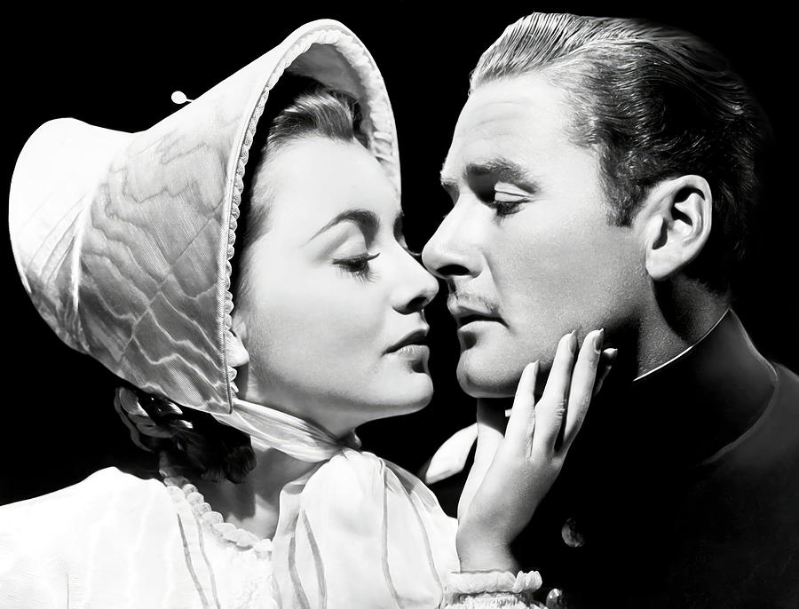 OLIVIA DE HAVILLAND and ERROL FLYNN in THE SANTA FE TRAIL -1940-, directed by MICHAEL CURTIZ. Photograph by Album