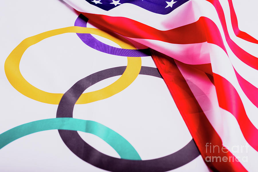 Olympic flag folded under the American flag after collecting the materials for the Olympic games aft Photograph by Joaquin Corbalan