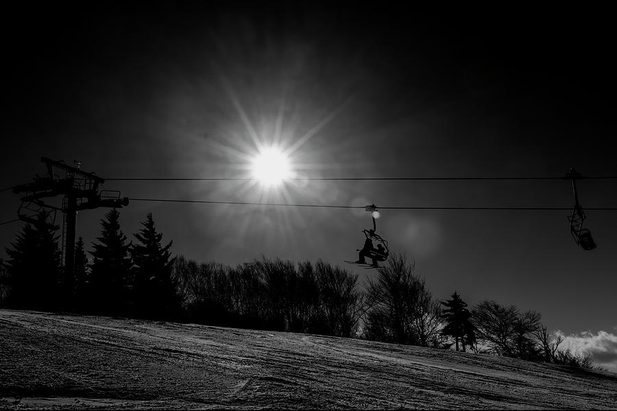 On ski lift heading up mountain black and white Photograph by Dan Friend
