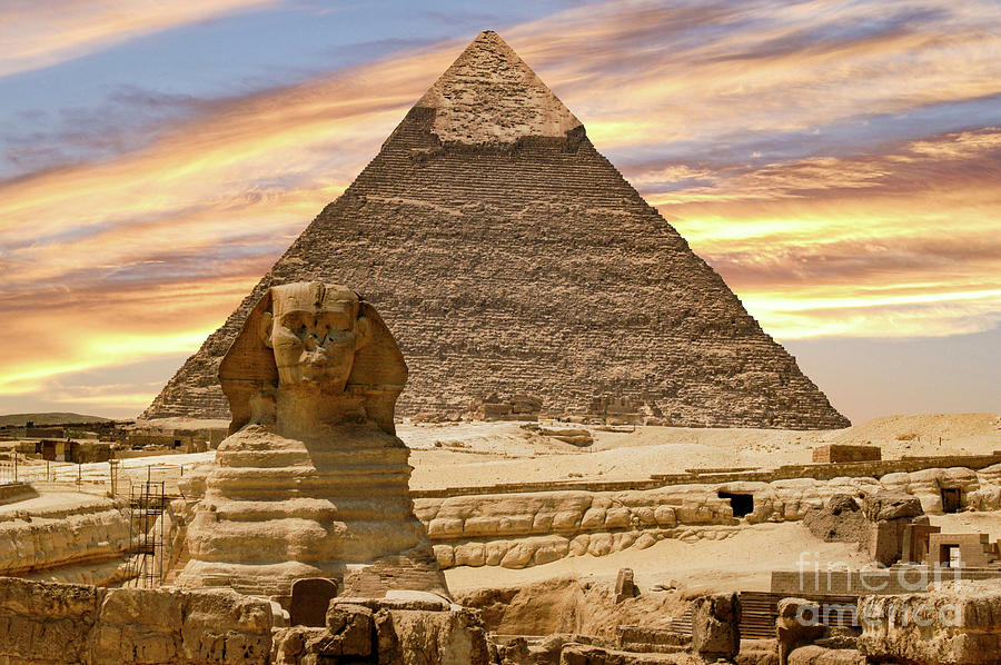 On the Giza Plateau in Egypt, the Great Sphinx of Giza and the Great Pyramids.. Photograph by Gunther Allen