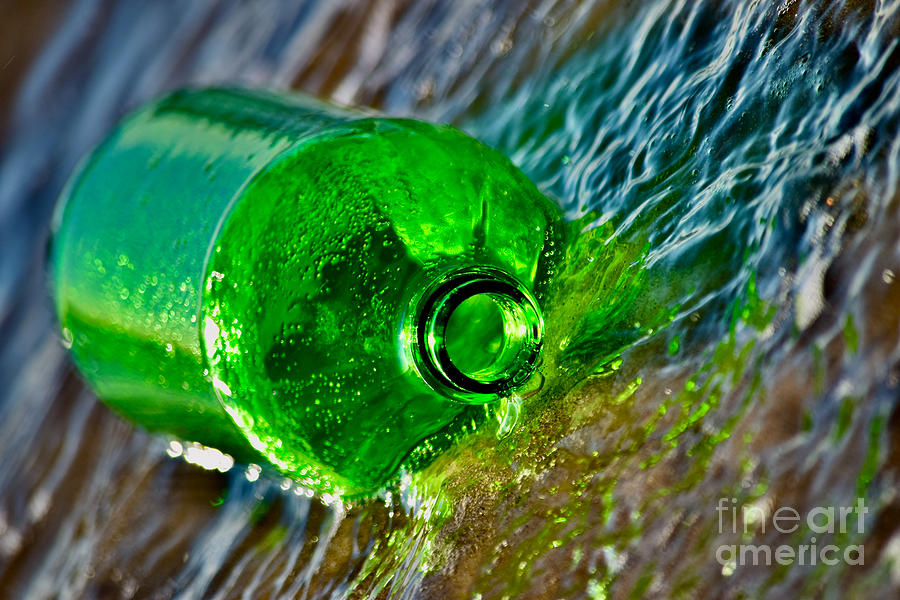 One Green Bottle Rolling with the Tide Photograph by Debra Banks