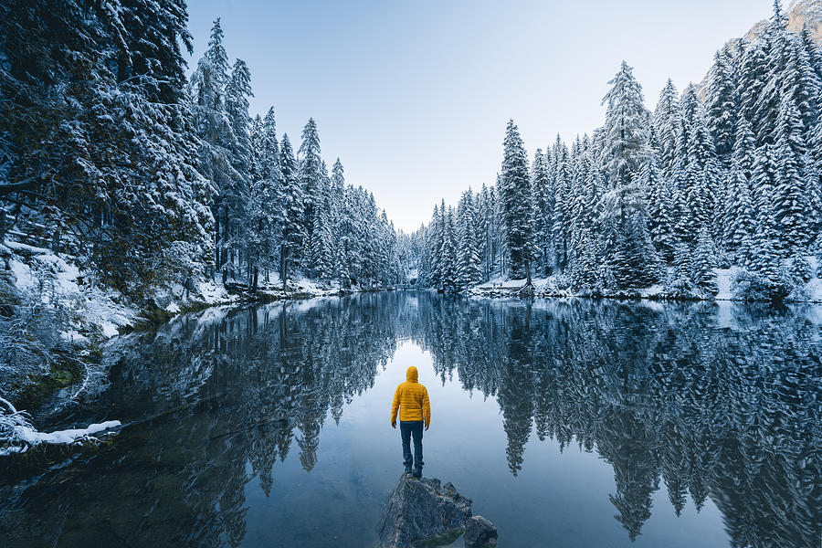 One person admiring a frost forest in the dolomites in winter, Italy Photograph by © Marco Bottigelli