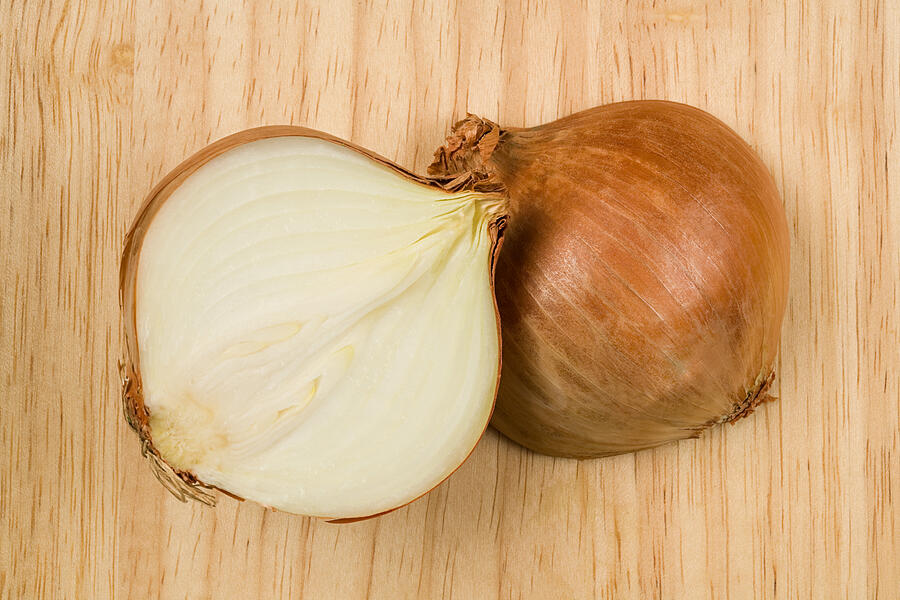 Onion cut in half Photograph by Image Source