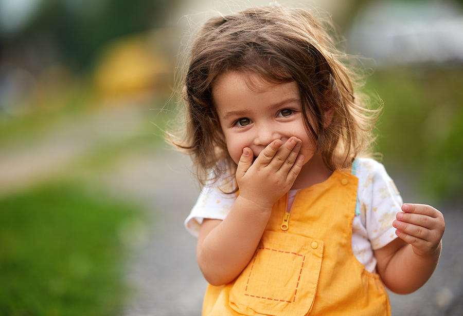 Oops! Little girl laughing Photograph by Stock_colors