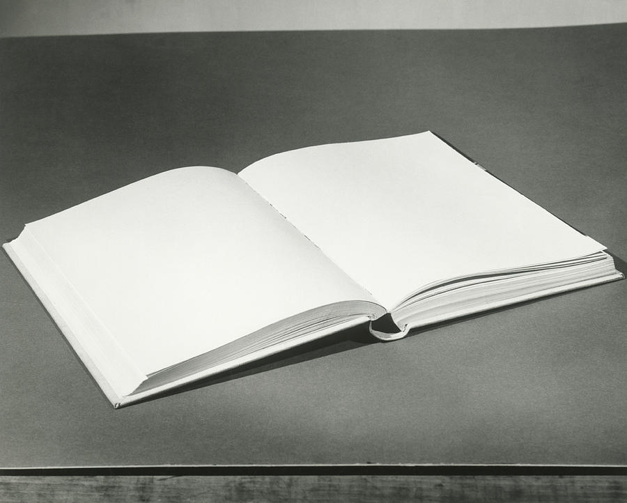 Open blank book on table Photograph by Fpg