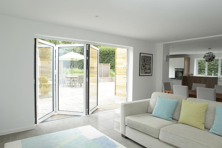 Open plan living area with open patio doors Photograph by Image Source