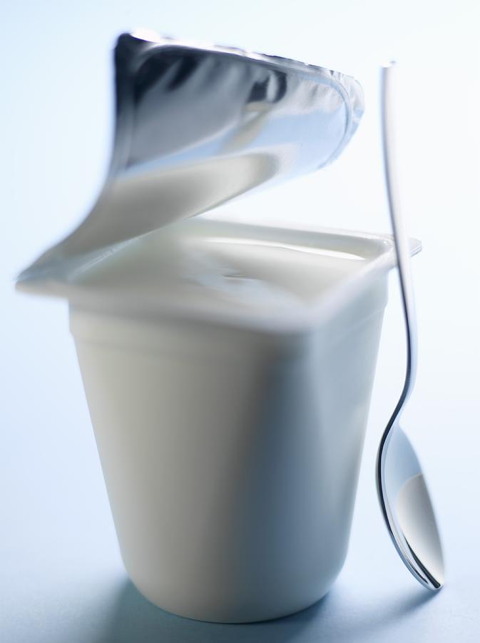 Open pot of yoghurt Photograph by Studio