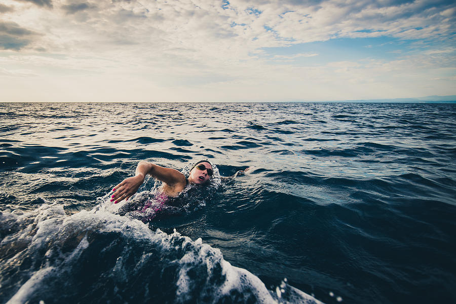 Open water swimmer swimming in sea Photograph by Simonkr