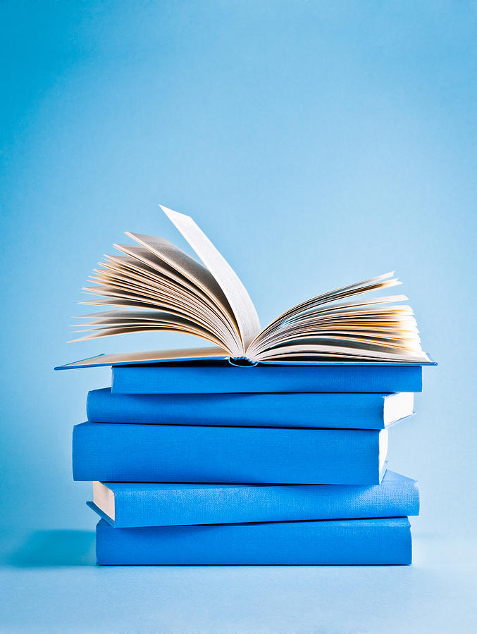 Opened book on top of stack of blue books, knowledge Photograph by Domin_domin