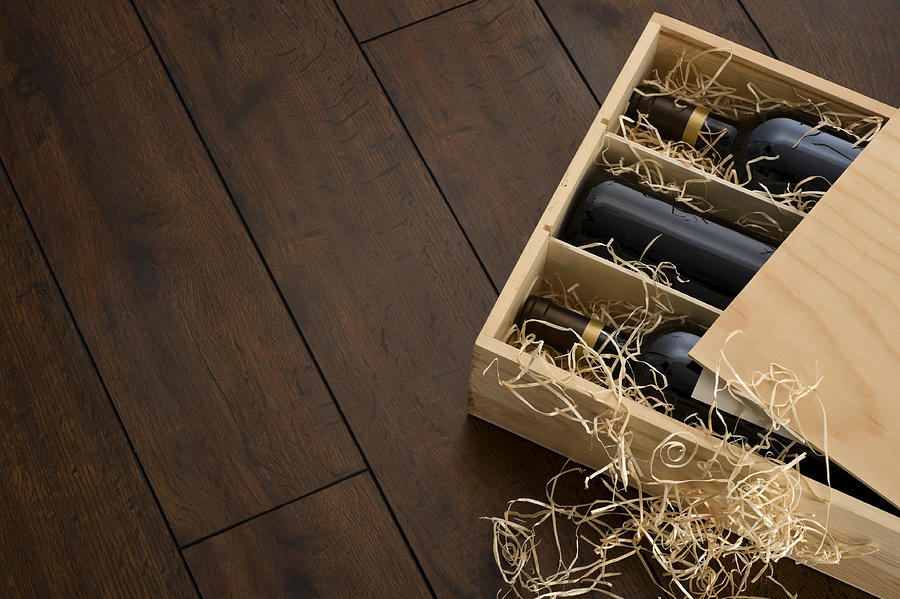 Opened wooden wine box packed with wine and straw Photograph by MarkSwallow