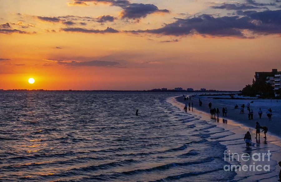 Orange ball of the setting sun at Fort Myers Beach Florida with Sanibel Island on the horizon Photograph by William Kuta