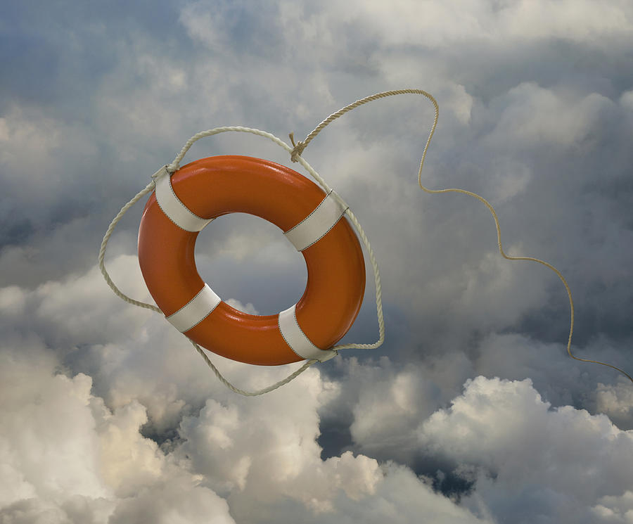 Orange life preserver floating in clouds Photograph by John M Lund Photography Inc