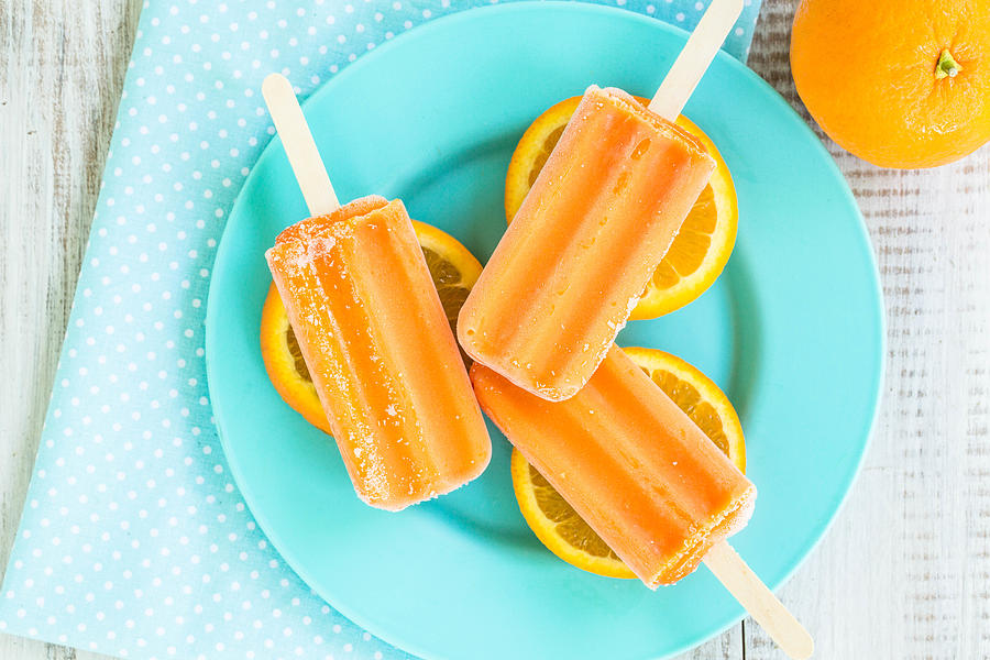 Orange Popsicles on Blue Dish Summer Dessert Photograph by Carolmellema