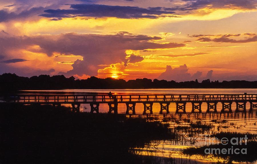 Orange sunset and a lone fisherman over Lake Mineola at Clermont Florida USA Photograph by William Kuta