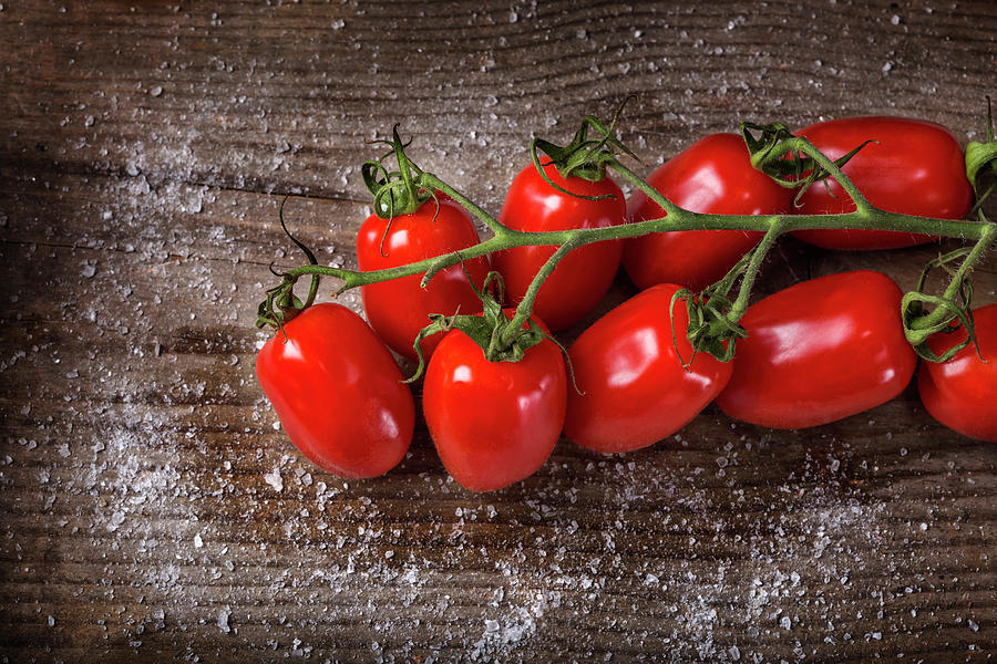 Organic cherry tomatoes with salt over wood Photograph by Sebastian Radu