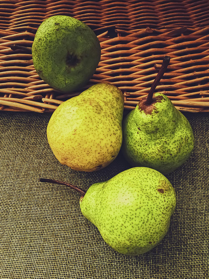 Organic pears on rustic linen background Photograph by Anneleven