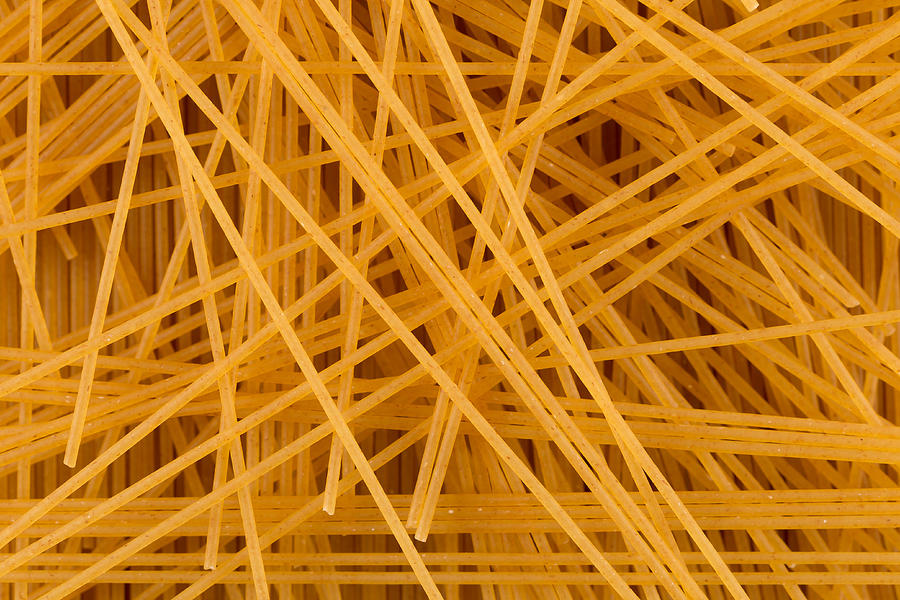Organic whole wheat spaghetti pasta for background Photograph by R.Tsubin