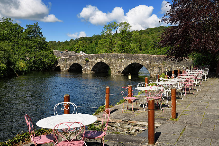 Outdoor patio tables and chairs of the Swan Hotel along the Rive Photograph by Reimar Gaertner