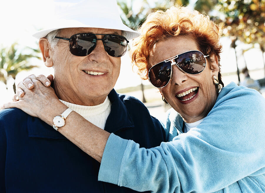 Outdoor Portrait of a Happy Senior Couple Wearing Sunglasses Photograph by Digital Vision.