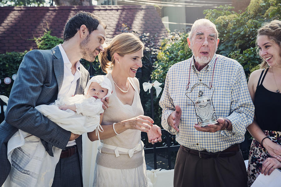Outdoors baby baptism with family and celebrant. Photograph by Martinedoucet