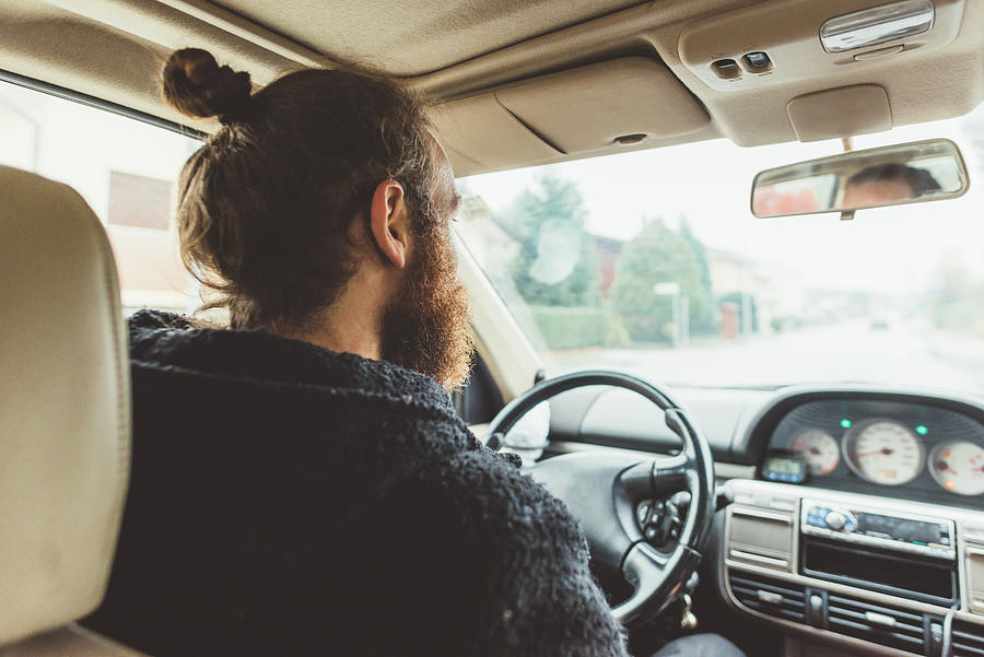 Over shoulder view of bearded man driving a car Photograph by Eugenio Marongiu