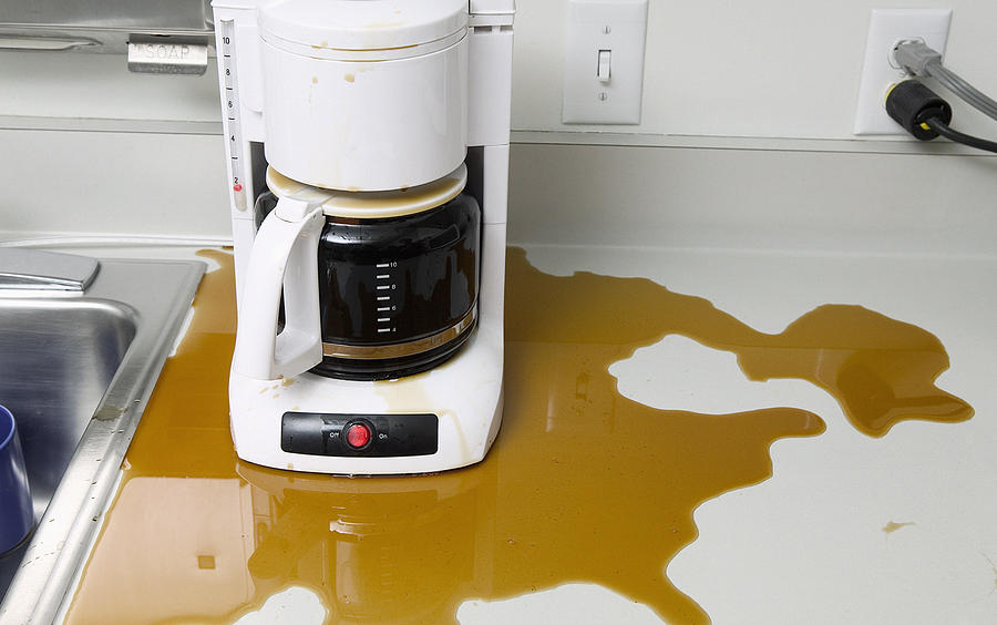 Overflowing coffee maker Photograph by Bill Varie