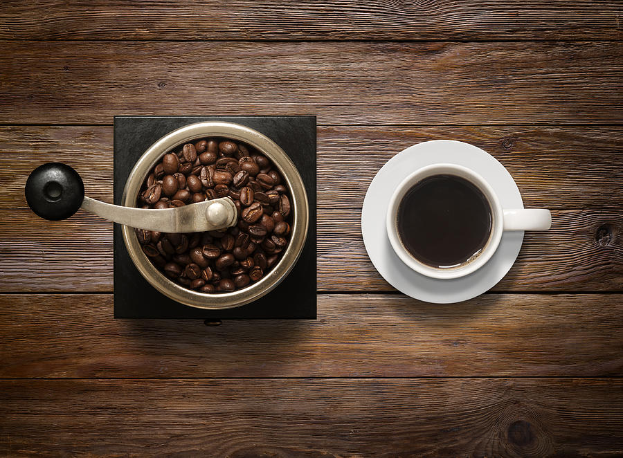 Overhead shot of Coffee Cup and Grinder on Wooden Background Photograph by Rbozuk