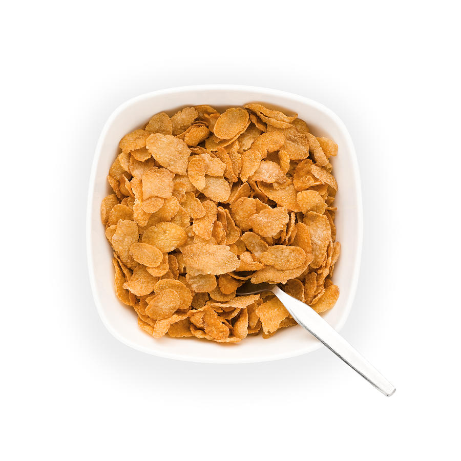 Overhead view of Bowl of Corn flakes with spoon Photograph by Creative Crop