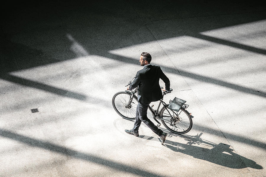 Overhead View On Elegant Businessman Going With Bycicle In City Photograph by Golero