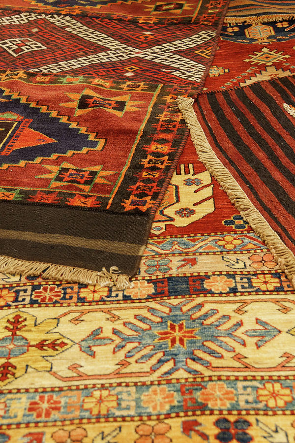 Overlapping carpets with intricate Kurdish  patterns Photograph by Steve Estvanik