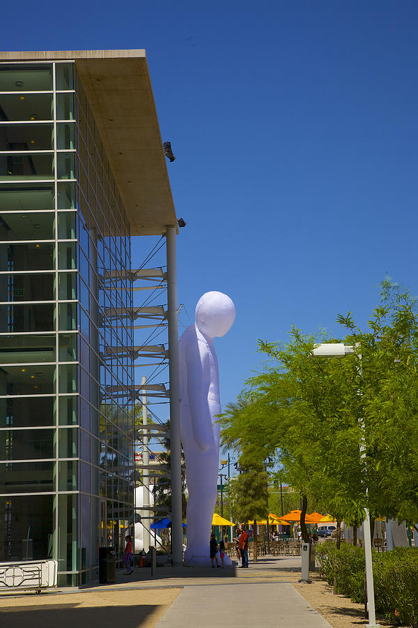 Oversize inflated balloon of a human against wall of Mesa, AZ art center Photograph by Barry Winiker