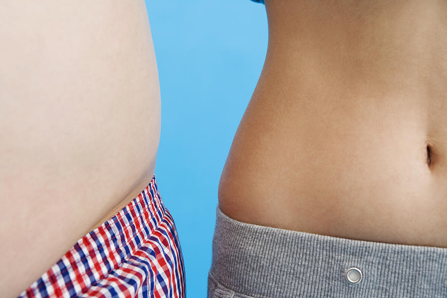 Overweight stomach next to a slim stomach Photograph by Daj