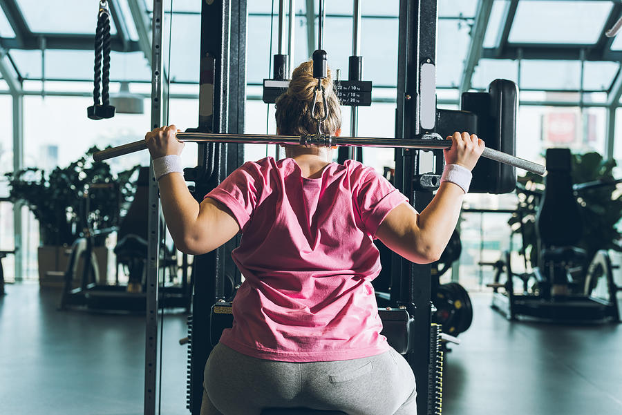 Overweight Woman Working Out On Training Apparatus Photograph by LightFieldStudios