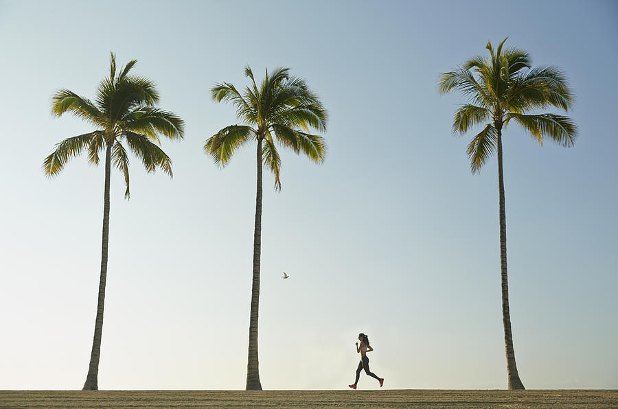 Pacific Islander woman running on beach Photograph by Colin Anderson Productions pty ltd