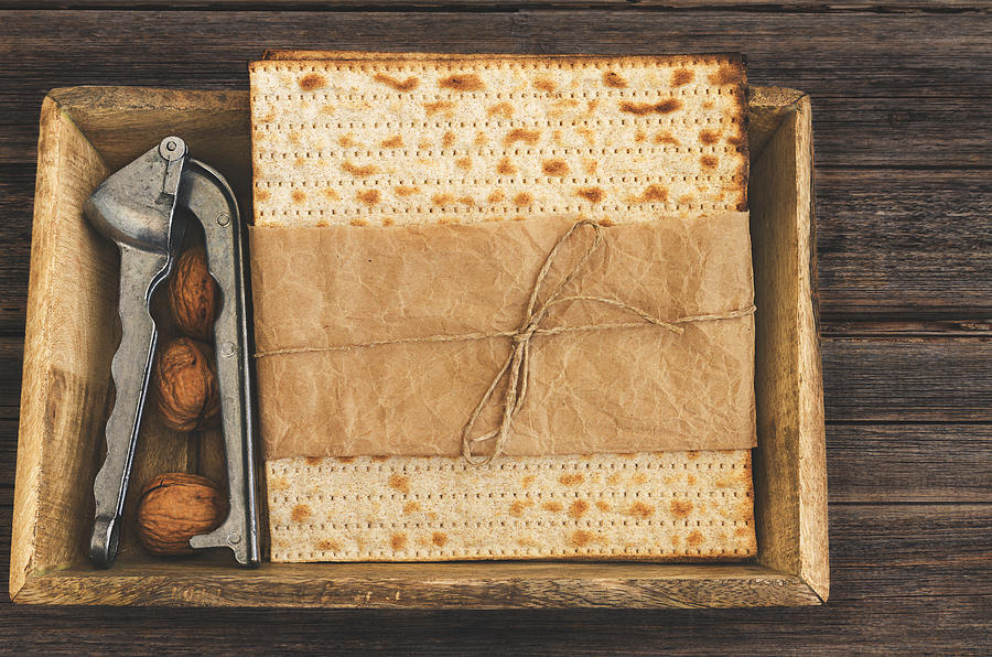 Pack of matzah or matza on a vintage wood background presented as a gift. Photograph by Vlad Fishman