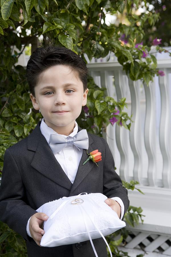 Page boy holding wedding rings Photograph by Image Source