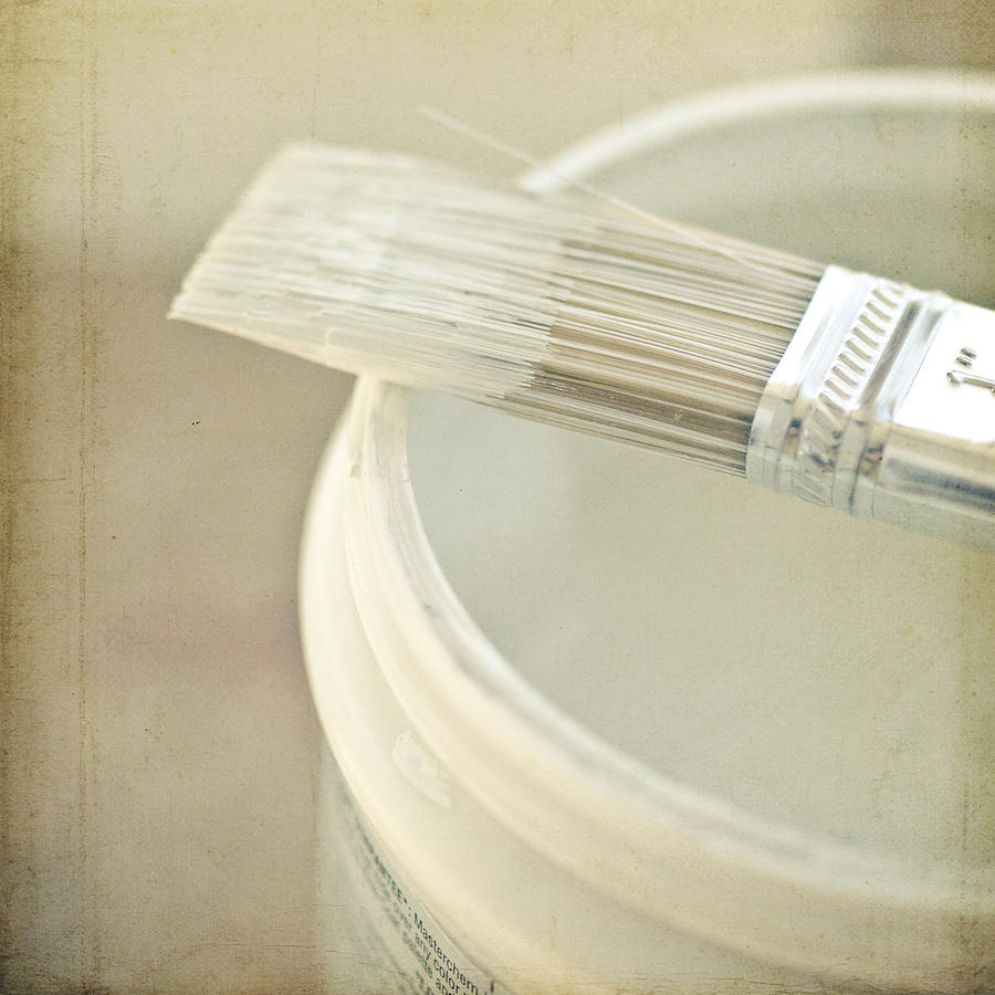 Paintbrush dipped in cream paint Photograph by Keli Hoskins