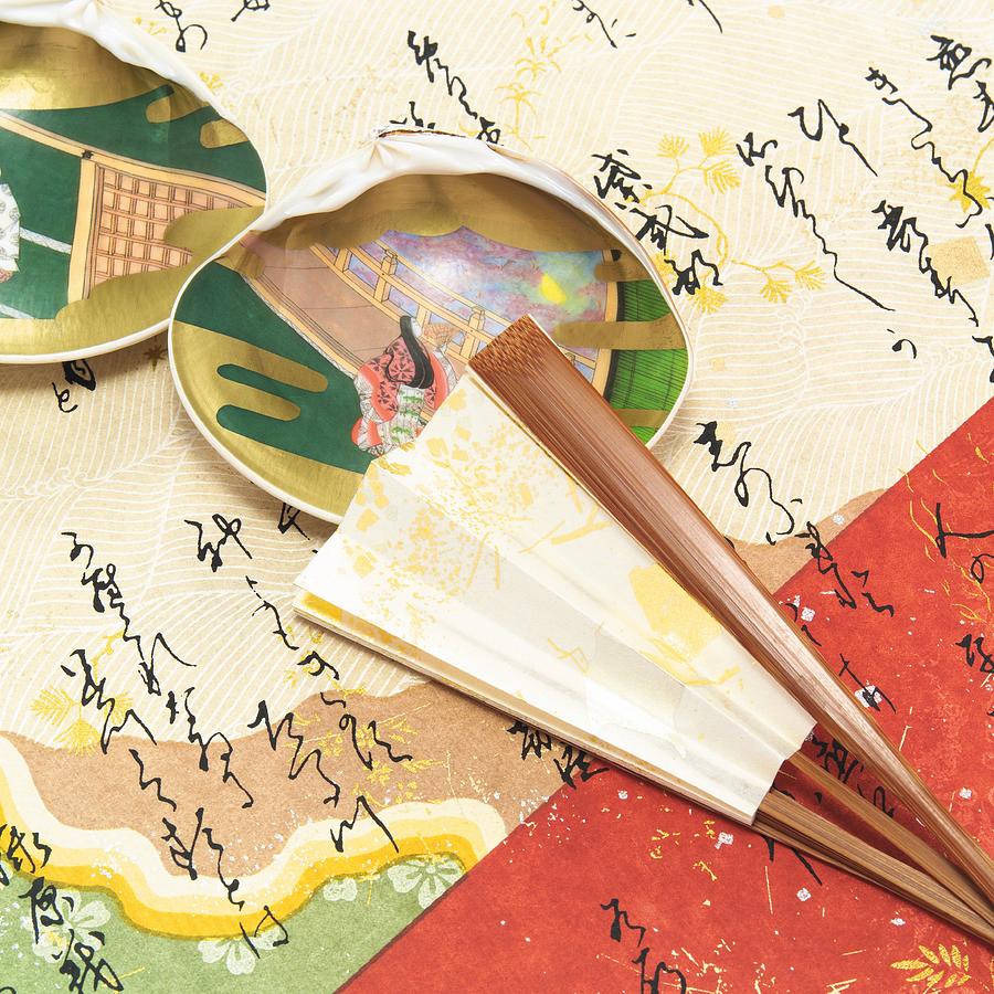 Painted clamshells and Japanese folding fan on paper written Japanese poem, high angle view Photograph by Daj