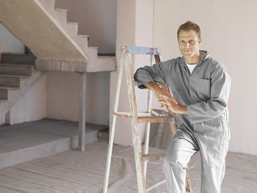 Painter posing with ladder in unfinished room Photograph by Robert Daly