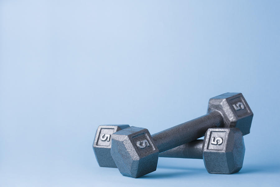 Pair of dumbbells on blue background Photograph by Kristin Lee