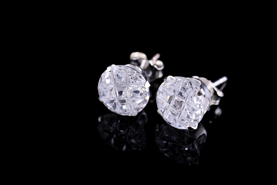 Pair of silver diamond stud earrings on a black background Photograph by ProArtWork
