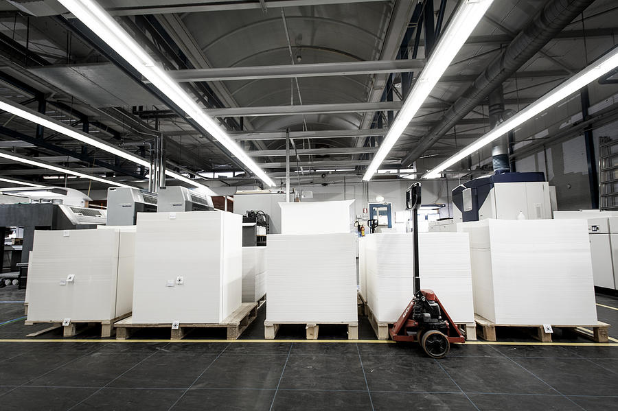 Pallets of paper in printing warehouse Photograph by Arno Masse