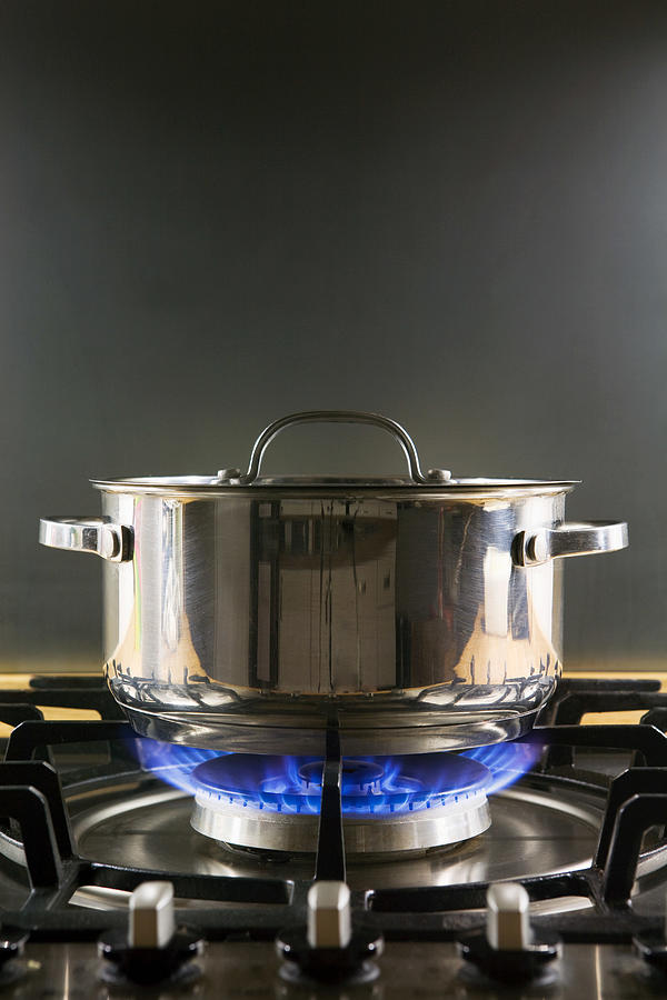 Pan on a gas hob Photograph by Image Source