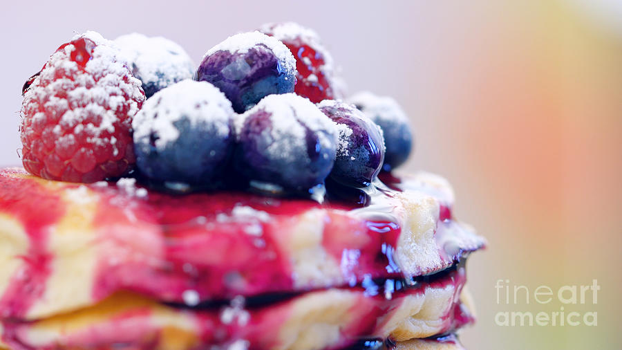 Raspberry Photograph - Pancakes with berries and drizzled with blueberry maple syrup, macro closeup. by Milleflore Images